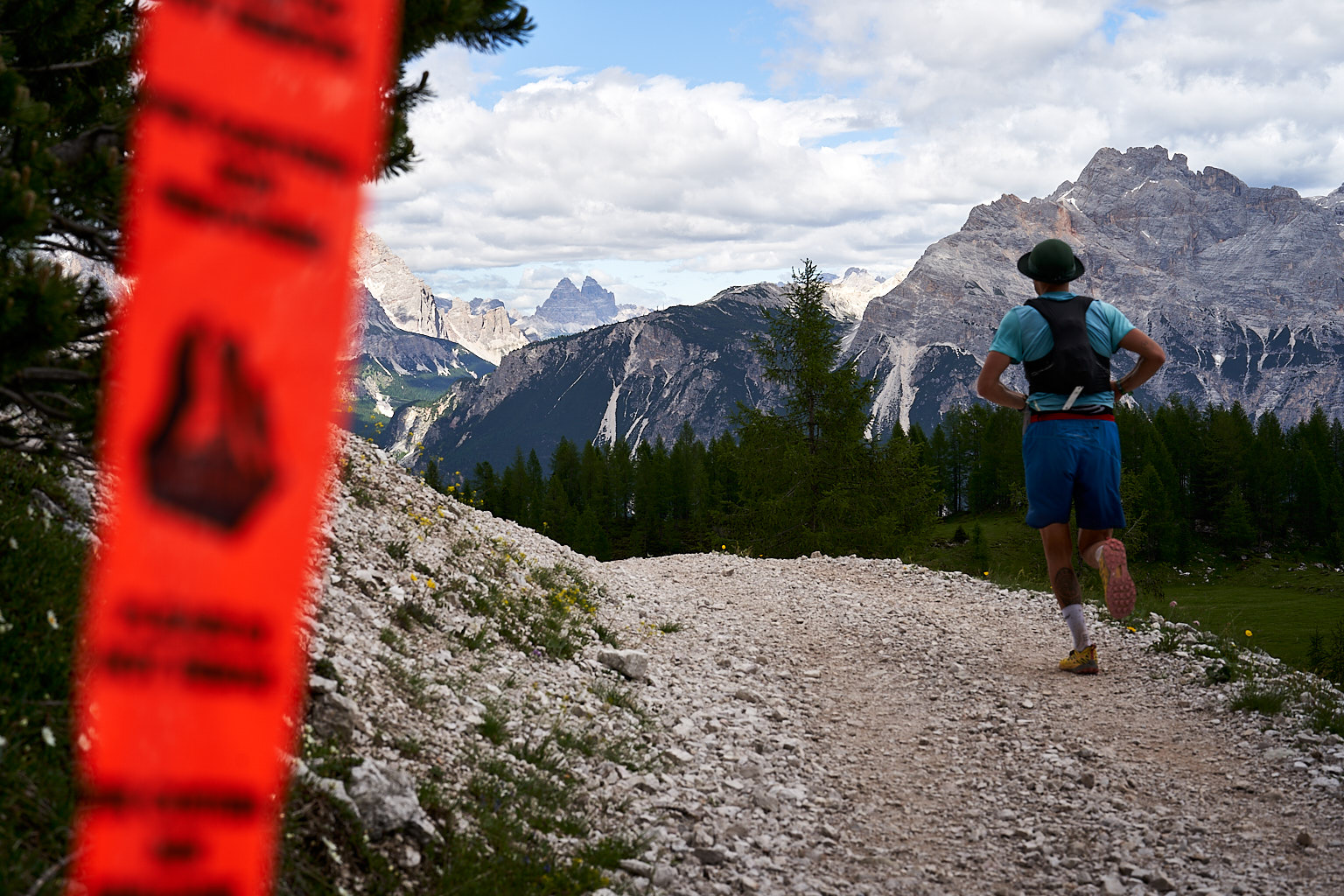 Runner in Croda da Lago area and the Tre Cime di Lavaredo on the background, Cortina d'Ampezzo @ Lavaredo Ultra Trail 2023
